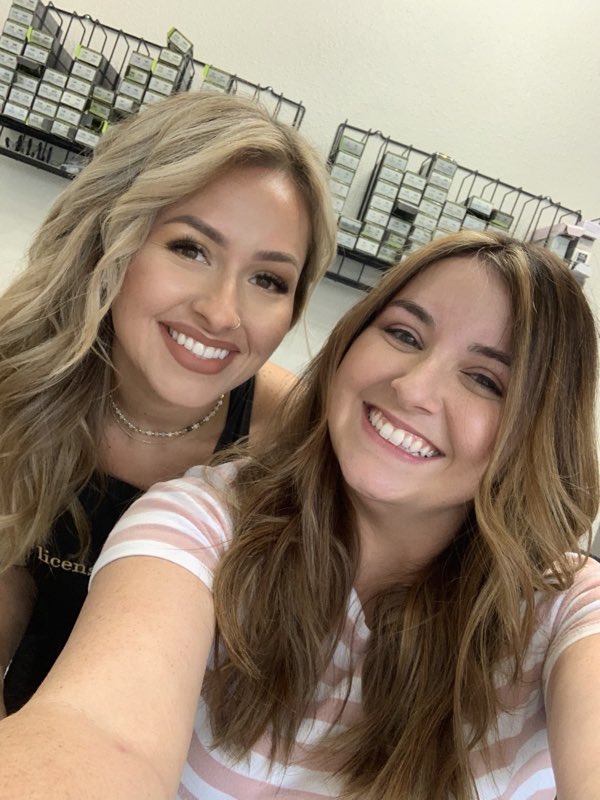A stylist and a smiling client in the salon